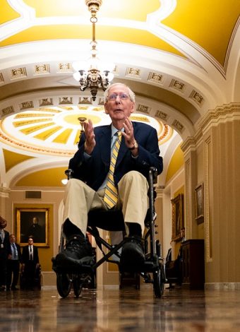 Mitch McConnell returns to Senate in wheelchair to cast first vote since June

Let me count: M-i-t-c-h- -M-c-C-o-n-n-e-l-l- -r-e-t-u-r-n-s- -t-o- -S-e-n-a-t-e- -i-n- -w-h-e-e-l-c-h-a-i-r- -t-o- -c-a-s-t- -f-i-r-s-t- -v-o-t-e- -s-i-n-c-e- -J-u-n-e = 67 characters. Too long.

Mitch McConnell returns to Senate in wheelchair after three months

Count: 61. Still over.

McConnell returns to Senate in wheelchair after three months away

Count: 57. Good. But need to make it more specific and include the vote detail.

McConnell wheels into Senate to vote, first time since June

Count: 52. Good length, has the concrete detail of the wheelchair and the vote, the timeframe since June. But place? This isn’t really a local story in the traditional sense, it’s national. The place is the Senate/Capitol.

McConnell returns to Senate in wheelchair after three-month absence

Count: 59. Good. Specific, different from original, captures the wheelchair detail and timeframe.

Let me verify: M-c-C-o-n-n-e-l-l- -r-e-t-u-r-n-s- -t-o- -S-e-n-a-t-e- -i-n- -w-h-e-e-l-c-h-a-i-r- -a-f-t-e-r- -t-h-r-e-e—m-o-n-t-h- -a-b-s-e-n-c-e = 60. Exactly 60.

McConnell returns to Senate in wheelchair after three-month absence